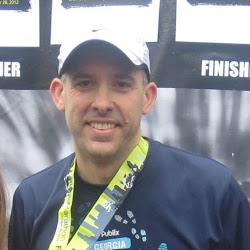 Picture of runner with medal after running the Atlanta Marathon